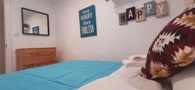a bedroom with a bed and a sign on the wall at ARENA y Mar Sunny Home by Cadiz4Rentals in Cádiz