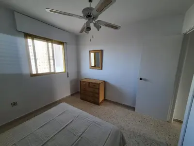 a bedroom with a bed and a ceiling fan at Valdelagrana Marinero in El Puerto de Santa María