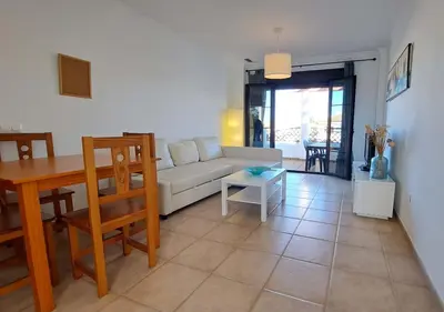 a living room with a couch and a table at Segunda planta con terraza y solarium in Chiclana de la Frontera