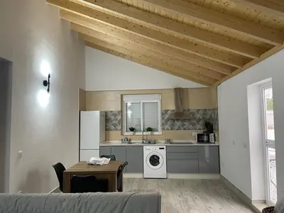 a kitchen with a sink and a washing machine at Casa Delia in Bornos