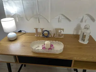 a table with a candle and a lamp on it at Casa Delia in Bornos