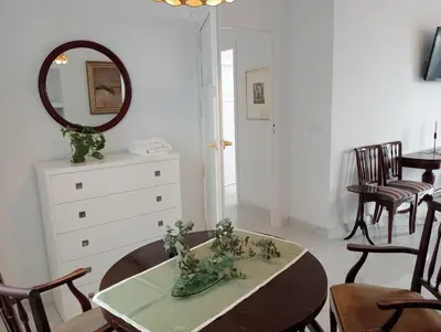 a dining room with a table and a mirror at Casa Palacio Madre de la Eucaristía in El Puerto de Santa María