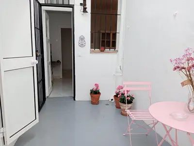 a room with a table and two chairs and a table with plants at Casa Palacio Madre de la Eucaristía in El Puerto de Santa María