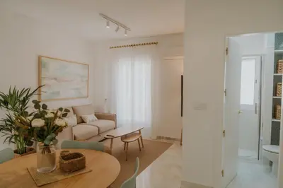 a living room with a couch and a table at Apartamento El Mazacote Sanlúcar de Barrameda in Sanlúcar de Barrameda