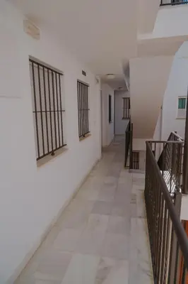 a hallway of a building with bars on the walls at Apartamento El Mazacote Sanlúcar de Barrameda in Sanlúcar de Barrameda