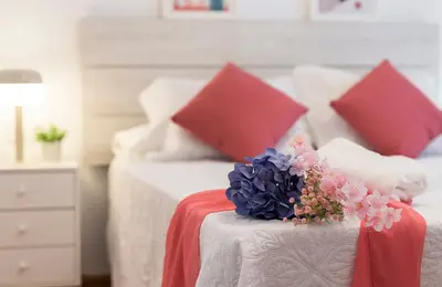 a bedroom with two beds with red and white pillows at Centrico Tranquilo 2 Rooms in Jerez de la Frontera