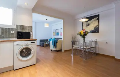 a kitchen and a living room with a washing machine at Centrico Tranquilo 2 Rooms in Jerez de la Frontera