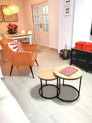a living room with a couch and a table and a chair at Oloroso Home CERCA CENTRO in Jerez de la Frontera