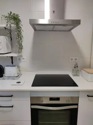 a kitchen with a stove top oven in a kitchen at Oloroso Home CERCA CENTRO in Jerez de la Frontera