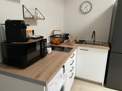 a kitchen with a counter with a microwave and a sink at Apartamentos Corredera 3 in Arcos de la Frontera