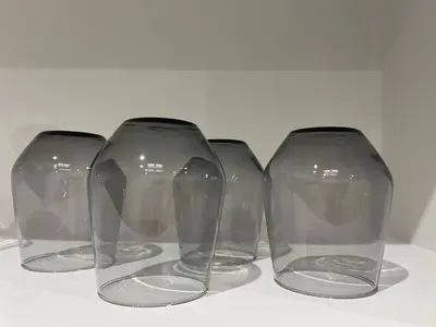 three empty glass vases sitting on a table at Apartamentos Corredera 3 in Arcos de la Frontera