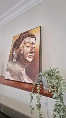 a picture of a statue on a shelf with a plant at Villas Luins in Chiclana de la Frontera