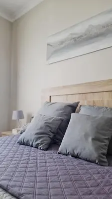 a bed with two pillows on it in a bedroom at Villas Luins in Chiclana de la Frontera