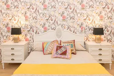 a bedroom with a bed with two nightstands and two lamps at Starlight in Cádiz