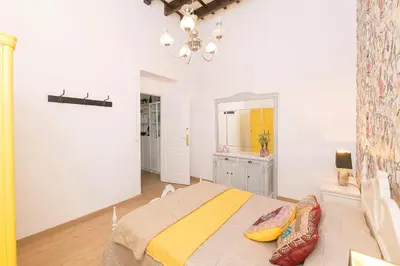 a bedroom with a bed and a dresser and a mirror at Starlight in Cádiz