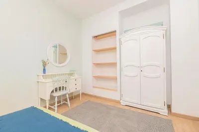 a bedroom with a white closet and a dressing table at Starlight in Cádiz