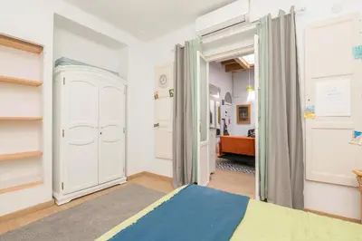 a bedroom with a bed and a hallway at Starlight in Cádiz
