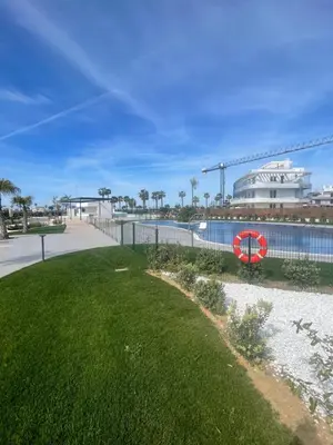 a yard with a red life preserver on a fence at Costa Ballena - Dos dormitorios, Piscina y Jardín privado in Cádiz