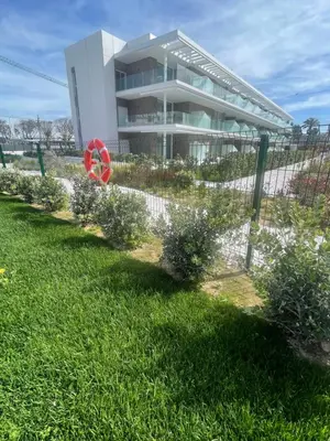 a building with a garden in front of it at Costa Ballena - Dos dormitorios, Piscina y Jardín privado in Cádiz