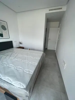 a white bedroom with a large bed in it at Costa Ballena - Dos dormitorios, Piscina y Jardín privado in Cádiz