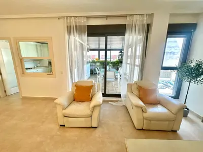 a living room with white couches and a table at GATU Cream, terraza, parking, aire acc, piscina común 
