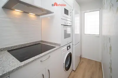 a kitchen with a sink and a washing machine at El Anfitrión - Carmen Viejo in Sanlúcar de Barrameda