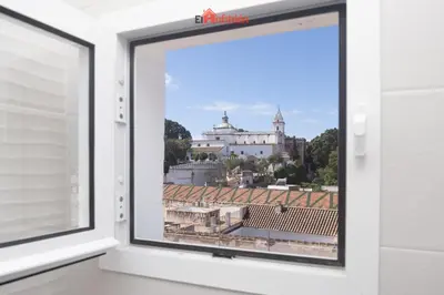 an open window with a view of a building at El Anfitrión - Carmen Viejo in Sanlúcar de Barrameda