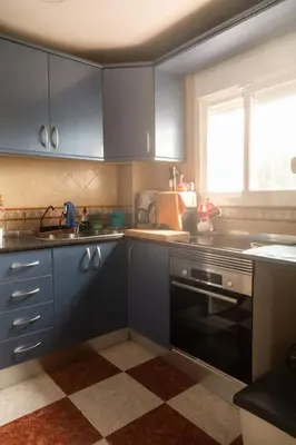 a kitchen with blue cabinets and a sink and a stove at Murillo by Gades Gestión in Cádiz