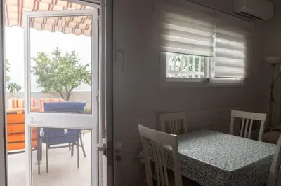 a dining room with a table and chairs and a window at Murillo by Gades Gestión in Cádiz