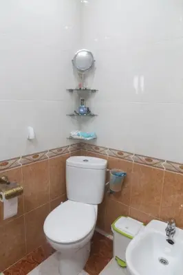 a bathroom with a white toilet and a sink at Murillo by Gades Gestión in Cádiz