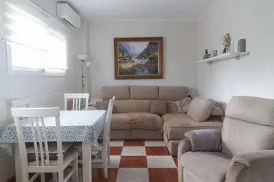 a living room with a couch and a table at Murillo by Gades Gestión in Cádiz