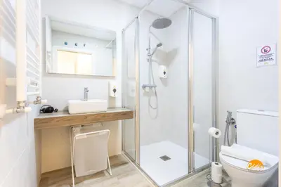 a bathroom with a shower and a toilet and a sink at Bajo el Falla by Cadiz Time in Cádiz
