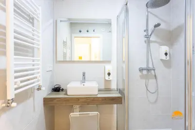 a bathroom with a sink and a shower at Bajo el Falla by Cadiz Time in Cádiz