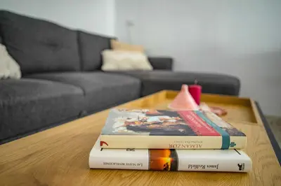 three books sitting on a coffee table in a living room at Apartamento céntrico con vistas in Arcos de la Frontera