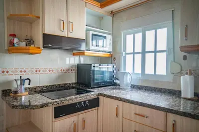 a kitchen with a sink and a stove top oven at Apartamento céntrico con vistas in Arcos de la Frontera