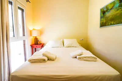 a bed in a room with two towels on it at La casita de la playa in Chiclana de la Frontera