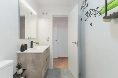 a bathroom with a sink and a mirror at Urbanización Jardín del Golf 1 in Novo Sancti Petri