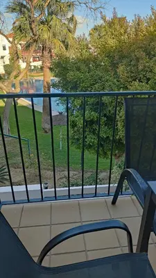 a chair and a table on a balcony at La Barrosa, Aldea del Coto in Novo Sancti Petri