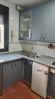 a living room with a dresser with a tv and a chair at La Barrosa, Aldea del Coto in Novo Sancti Petri