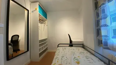 a small room with a bed and a mirror at GATU Villa Dante Playa Victoria Parking gratuito, 