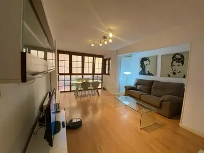 a living room with a couch and a table at GATU Villa Dante Playa Victoria Parking gratuito, 