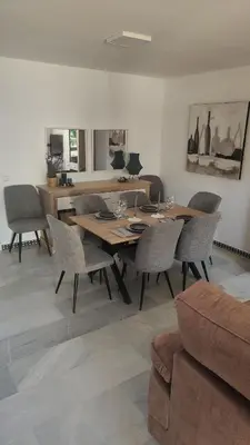a dining room with a wooden table and chairs at Novo Sancti Petri (Green 11) in Novo Sancti Petri