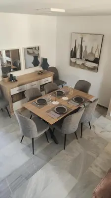 a dining room with a wooden table and chairs at Novo Sancti Petri (Green 11) in Novo Sancti Petri