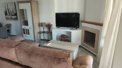 a living room with a couch and a flat screen tv at Novo Sancti Petri (Green 11) in Novo Sancti Petri