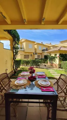a table with plates of food on a patio at Novo Sancti Petri (Green 11) in Novo Sancti Petri