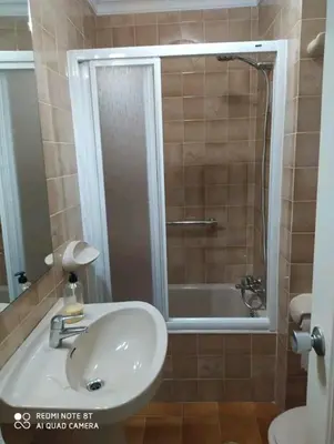 a bathroom with a sink and a bath tub at Piso primera línea de playa in Chipiona
