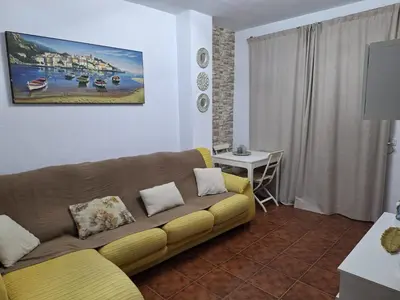 a living room with a couch and a table at El Deseo in Novo Sancti Petri