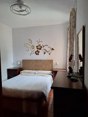 a bedroom with a bed and a desk and a table at El Deseo in Novo Sancti Petri