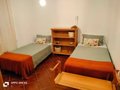 two beds sitting next to each other in a room at Habitación acogedora y sencilla in El Puerto de Santa María