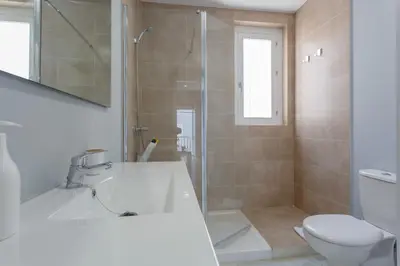 a bathroom with a shower and a toilet and a sink at Apartamento Cádiz Mirador by Isa in Cádiz